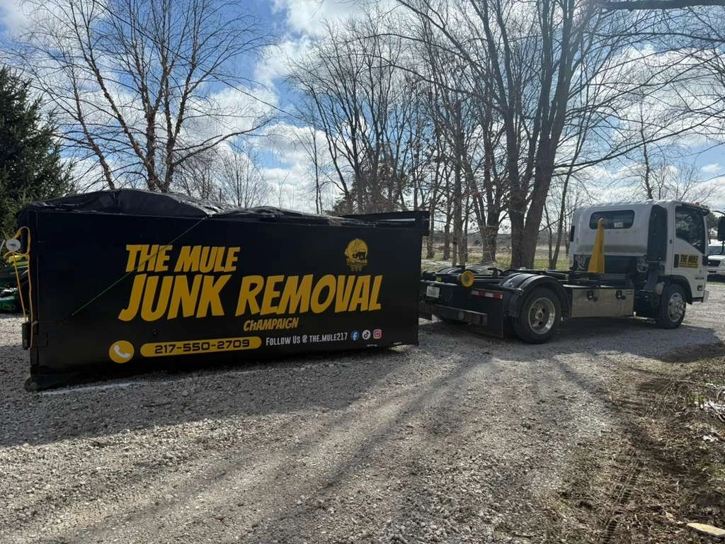 The Mule Junk Removal dumpster trailer and truck parked in Champaign Illinois ready for junk hauling and dumpster rental service